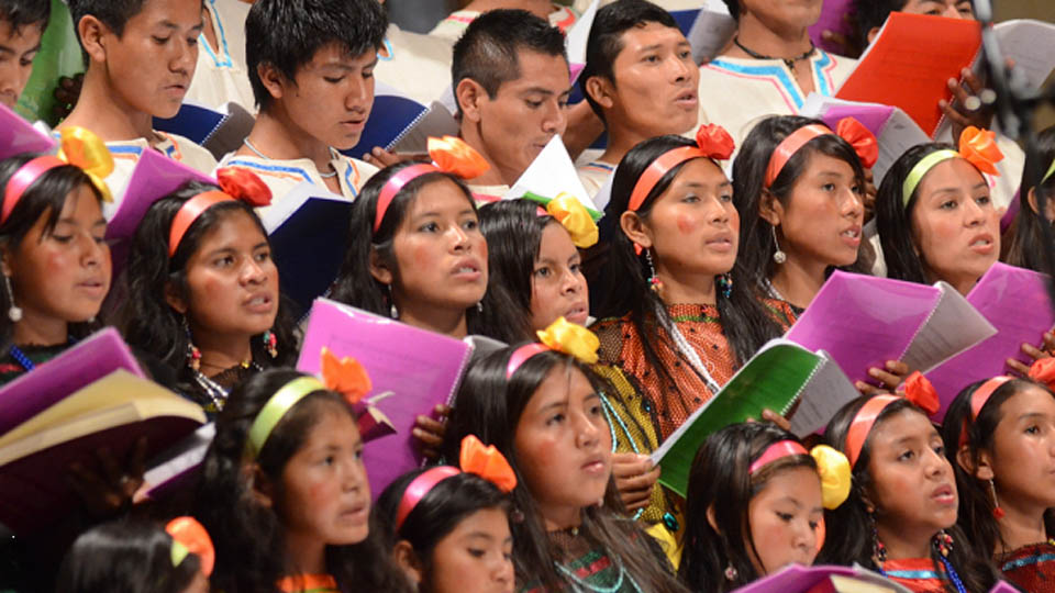 Bolivian singers in a baroque choir singing during a performance